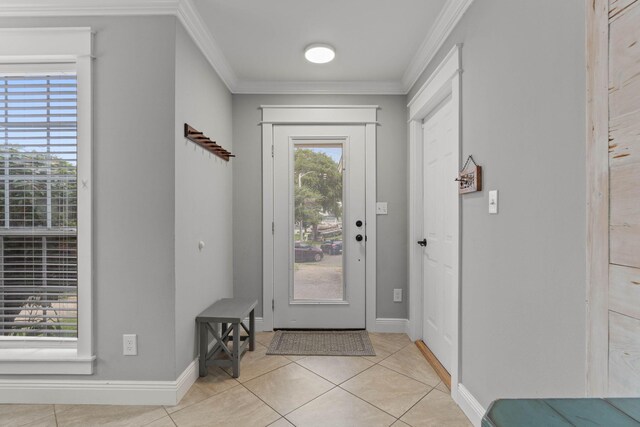 foyer with ornamental molding and light tile patterned flooring