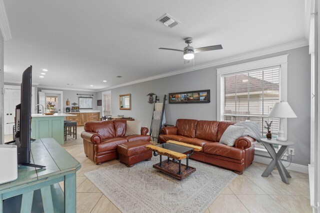 tiled living room featuring crown molding and ceiling fan