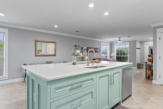 kitchen featuring a kitchen island with sink, green cabinetry, light tile patterned floors, ceiling fan, and stainless steel dishwasher