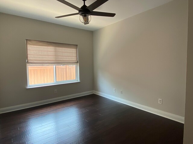 unfurnished room featuring ceiling fan and dark wood-type flooring