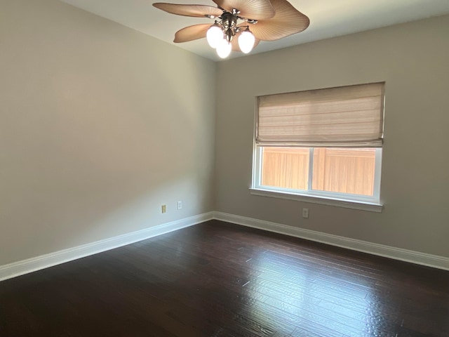 empty room with dark hardwood / wood-style floors and ceiling fan