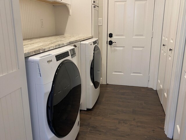 washroom featuring dark hardwood / wood-style floors and washer and clothes dryer