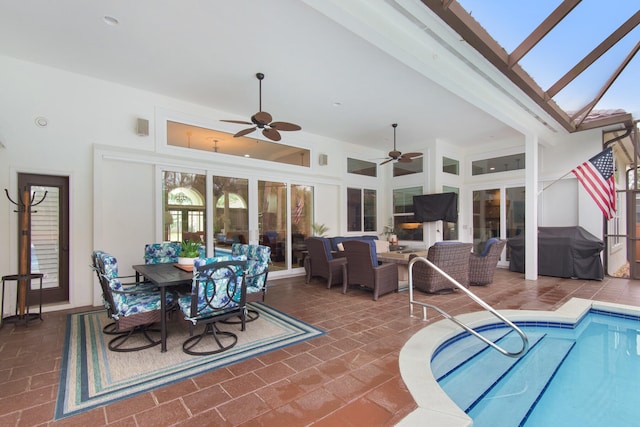 view of pool featuring outdoor lounge area, grilling area, ceiling fan, a lanai, and a patio area