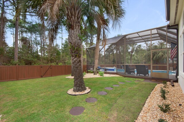 view of yard featuring a fenced in pool and a lanai