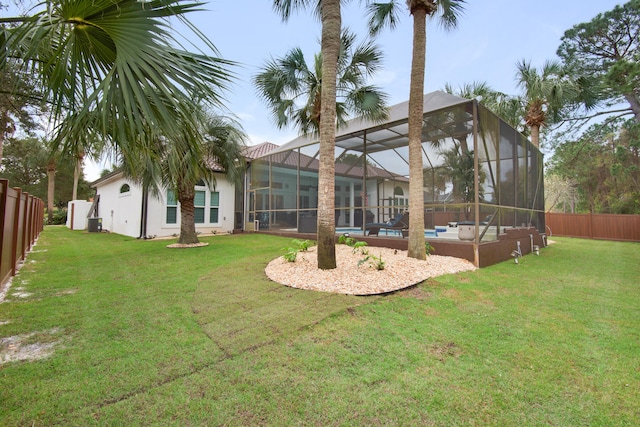 exterior space with a yard, a fenced in pool, and a lanai