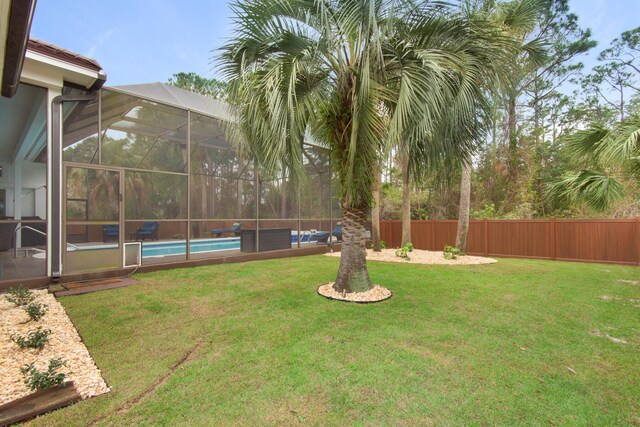 view of yard featuring a fenced in pool, an outdoor living space, and a lanai