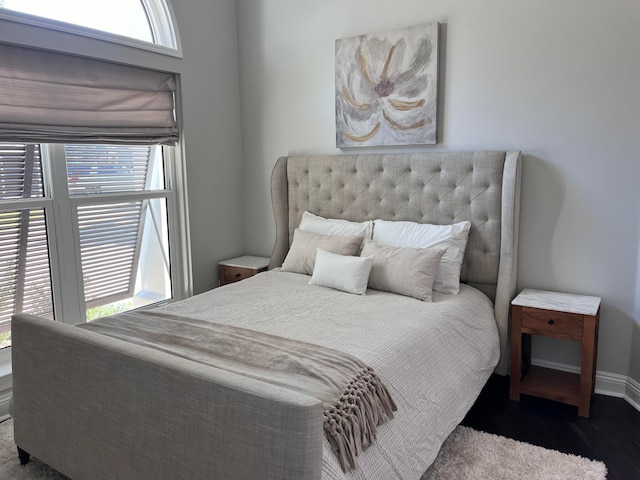 bedroom featuring hardwood / wood-style floors and multiple windows