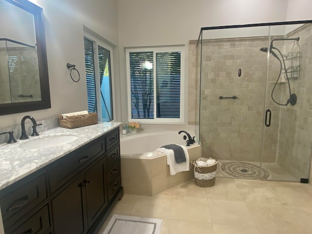 bathroom with tile patterned flooring, vanity, and independent shower and bath