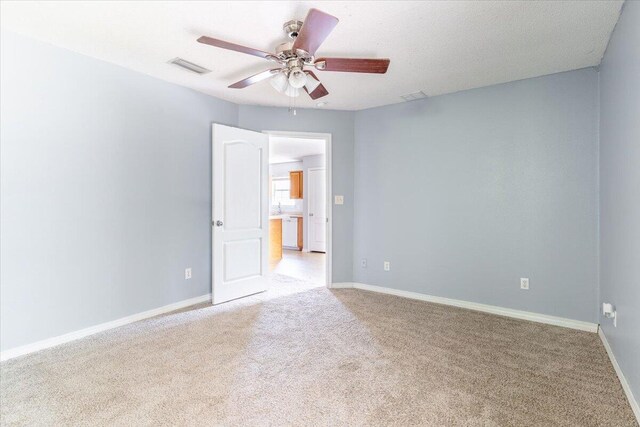 carpeted empty room with ceiling fan