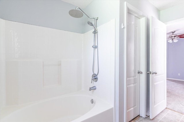 bathroom with tile patterned floors, ceiling fan, and  shower combination