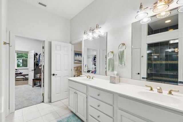 bathroom with vanity, tile patterned floors, and a shower with door