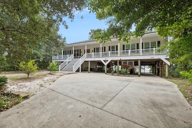 view of front of house with a porch and a carport