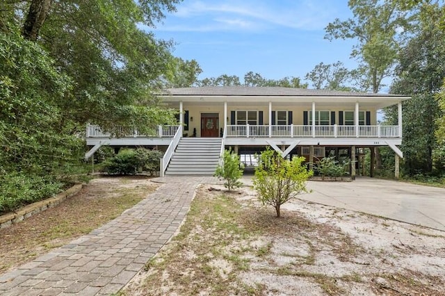 view of front of home with a carport and a porch