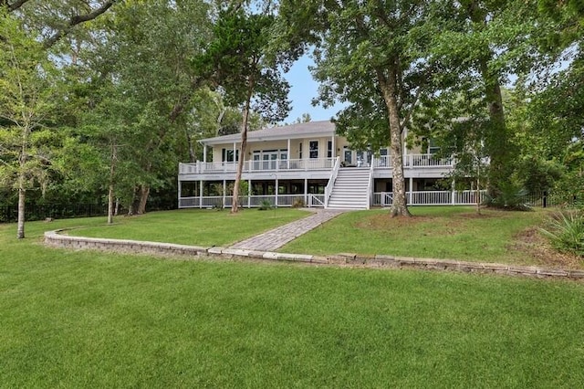 rear view of property featuring a yard and a deck