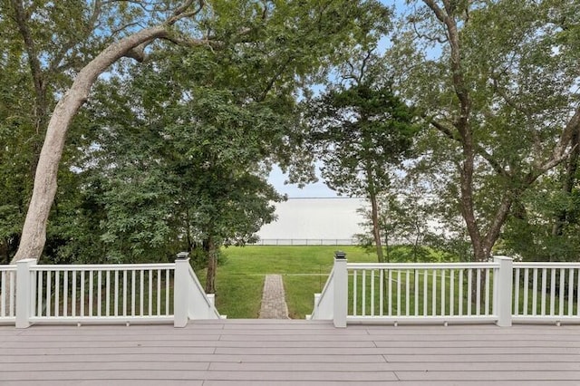 wooden deck featuring a lawn