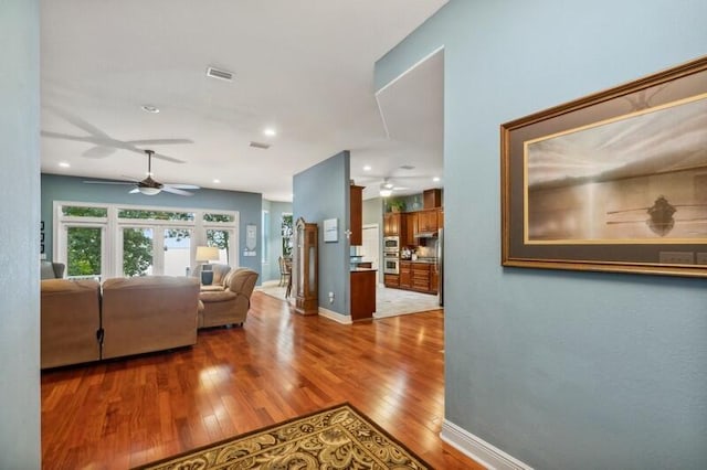 living room featuring french doors and hardwood / wood-style floors