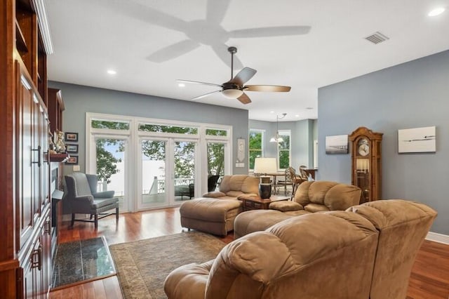 living room featuring dark hardwood / wood-style floors and ceiling fan