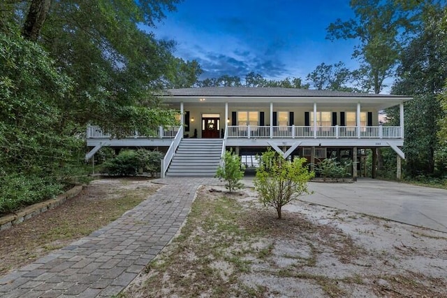 view of front of property featuring covered porch and a carport