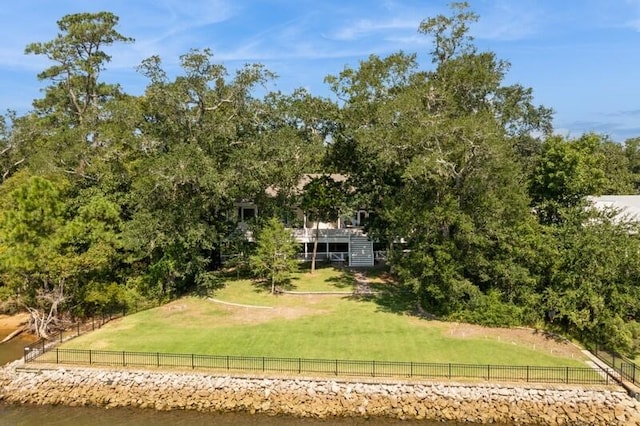 exterior space featuring a yard, a water view, and a rural view