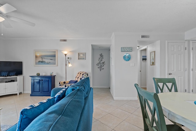 living room with ceiling fan, ornamental molding, and light tile patterned flooring