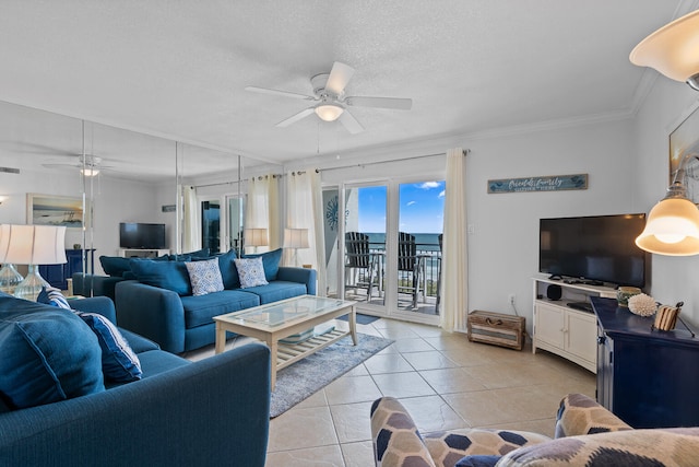 tiled living room featuring ceiling fan, a textured ceiling, and ornamental molding