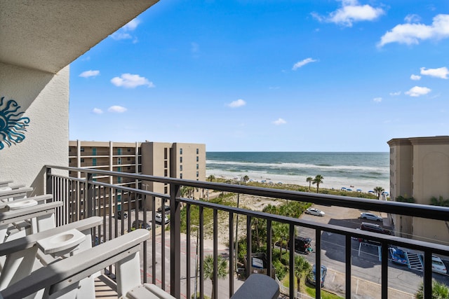 balcony with a view of the beach and a water view