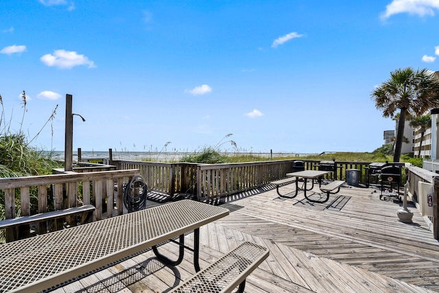 wooden terrace featuring a water view