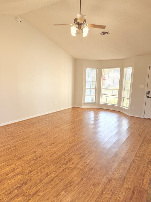 empty room featuring light hardwood / wood-style flooring, ceiling fan, and lofted ceiling