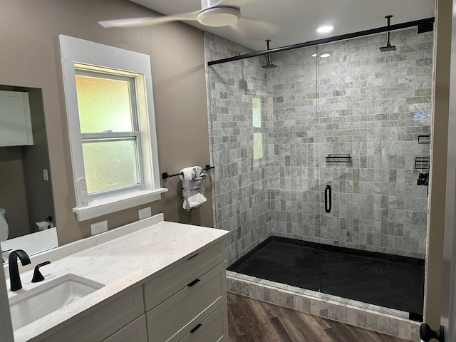 bathroom featuring vanity, hardwood / wood-style floors, and a shower with door