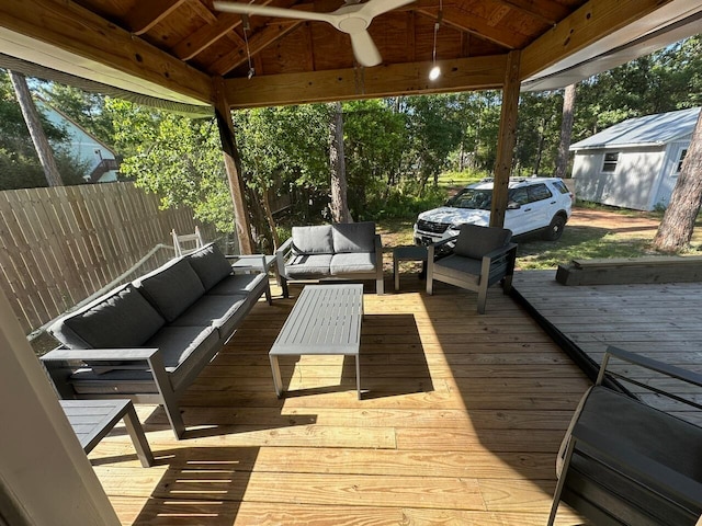 wooden terrace with ceiling fan and an outdoor hangout area