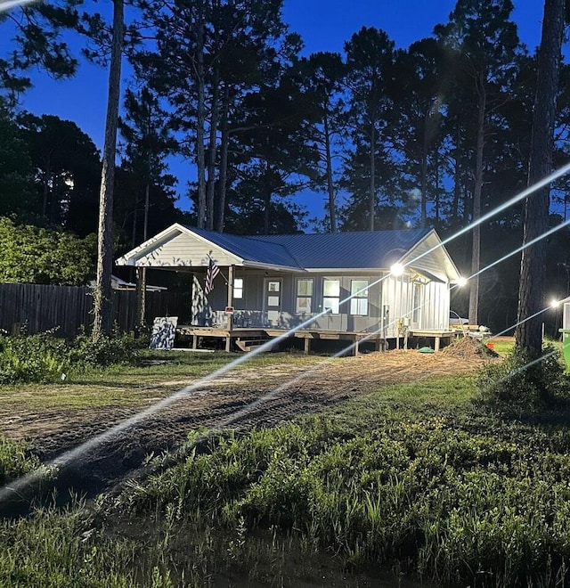 back house at twilight with a deck