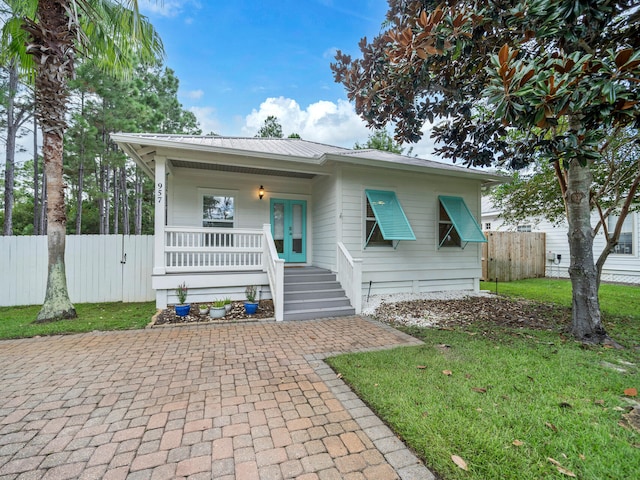 bungalow-style house with a front lawn and a porch