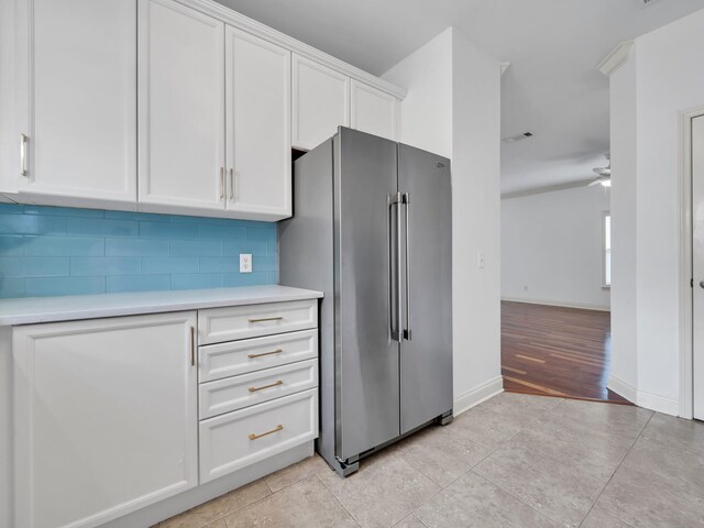 kitchen with white cabinetry, high end refrigerator, light hardwood / wood-style flooring, decorative backsplash, and ceiling fan