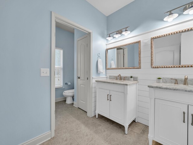 bathroom with vanity, toilet, and tile patterned floors