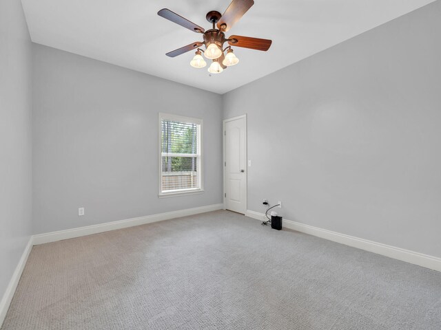 empty room featuring light carpet and ceiling fan