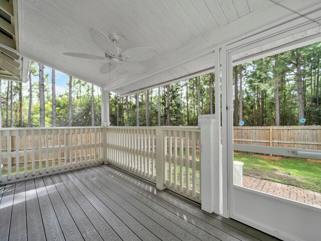 unfurnished sunroom with ceiling fan and plenty of natural light