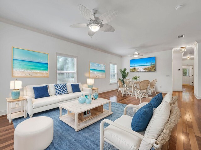 living room with ornamental molding, ceiling fan, and hardwood / wood-style flooring