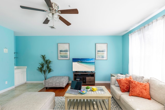 living room with hardwood / wood-style flooring and ceiling fan