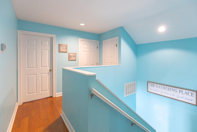 corridor with light hardwood / wood-style floors