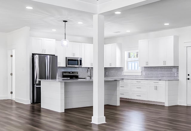 kitchen with sink, white cabinets, hanging light fixtures, stainless steel appliances, and dark wood-type flooring