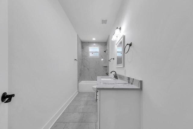 full bathroom featuring vanity, toilet, and tiled shower / bath combo