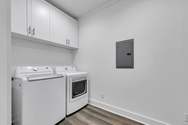 laundry room with dark hardwood / wood-style floors, washer and clothes dryer, electric panel, and cabinets