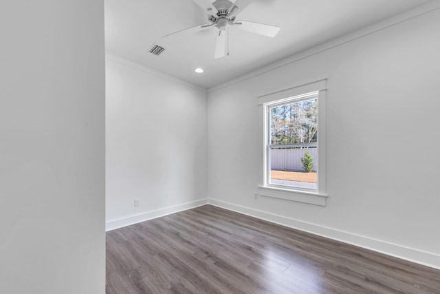 empty room featuring hardwood / wood-style floors, ornamental molding, and ceiling fan