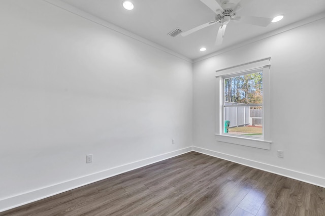 spare room featuring crown molding, dark hardwood / wood-style floors, and ceiling fan