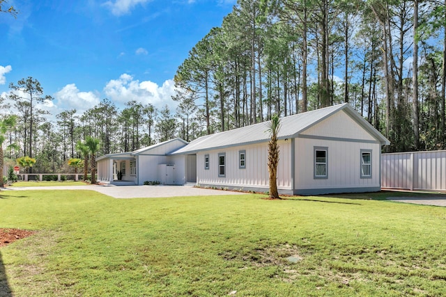 rear view of house featuring a yard