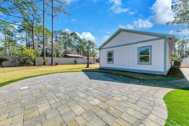 exterior space featuring a lawn, a patio, and central air condition unit