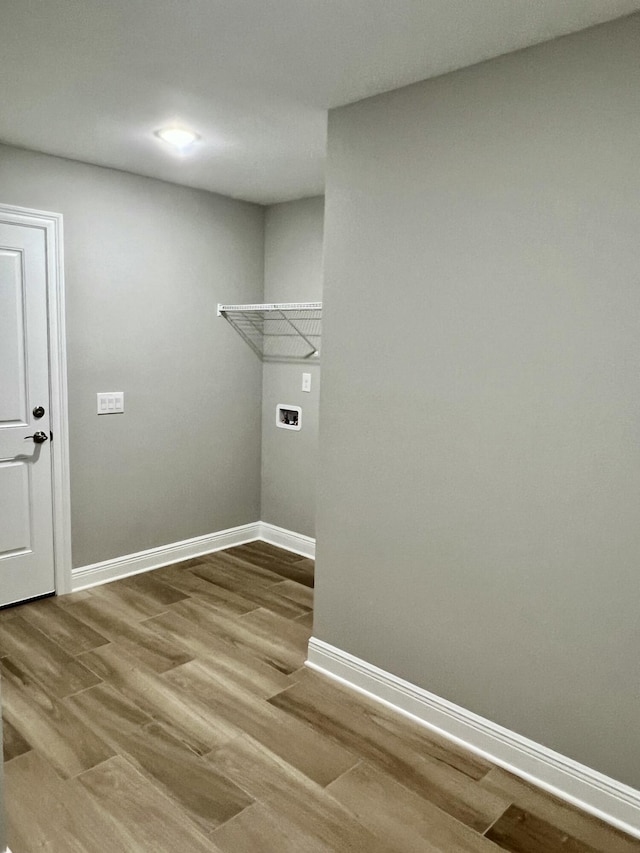 washroom featuring hardwood / wood-style flooring and hookup for a washing machine