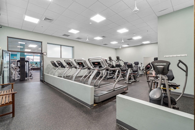 exercise room featuring a paneled ceiling