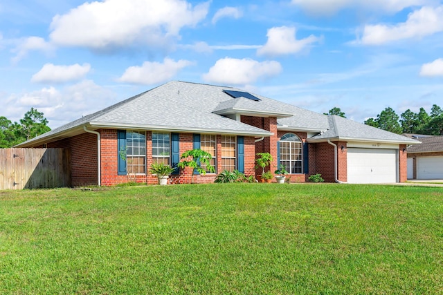 single story home with a front yard and a garage