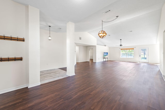 unfurnished living room with a textured ceiling, high vaulted ceiling, dark wood-type flooring, and ceiling fan with notable chandelier